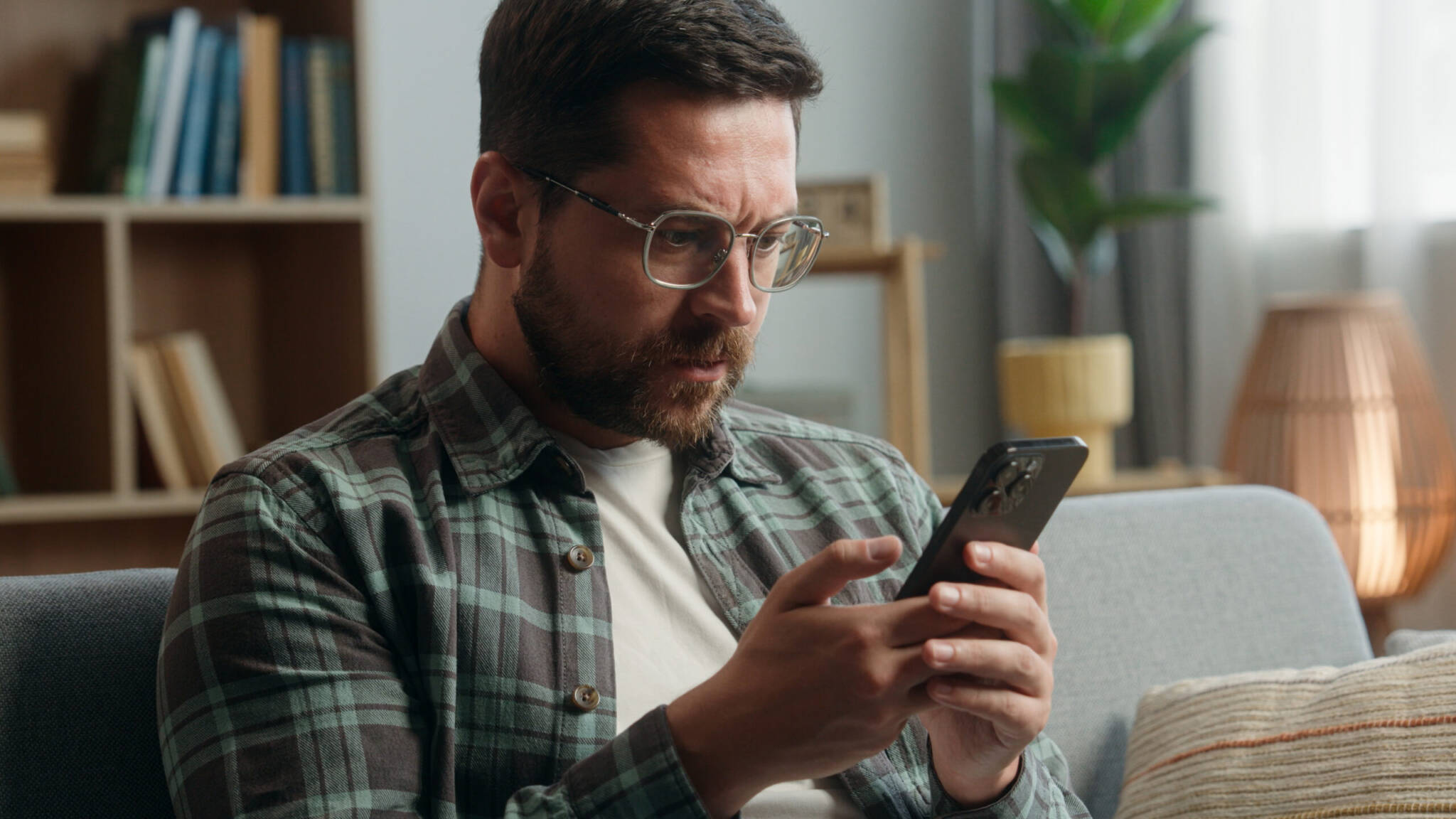 Caucasian Adult Man Male Guy At Home Living Room Nervous Looking At Mobile Phone Bad News Amazed Shocked Close Mouth With Hand Message From Bank Stressed Smartphone Notification Online Error Scam Caucasian Adult Man Male Guy At Home Living Room Nervous Looking At Mobile Phone Bad News Amazed Shocked Close Mouth With Hand Message From Bank Stressed Smartphone Notification Online Error Scam