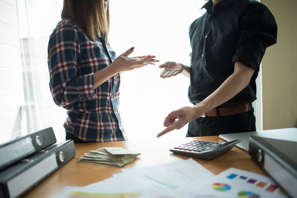 Close Up Of Business People Working With Business Document Durin