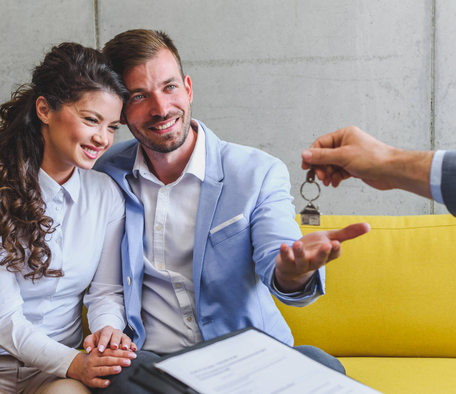 Real Estate Agent Handing Over House Keys To Young Married Couple Real Estate Agent Handing Over House Keys To Young Married Couple